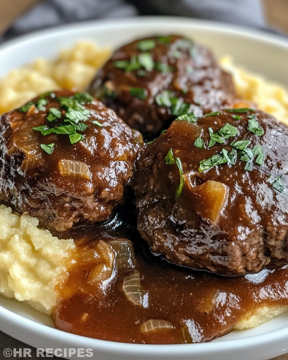 Tender Salisbury steak on plate with thick gravy and parsley garnish